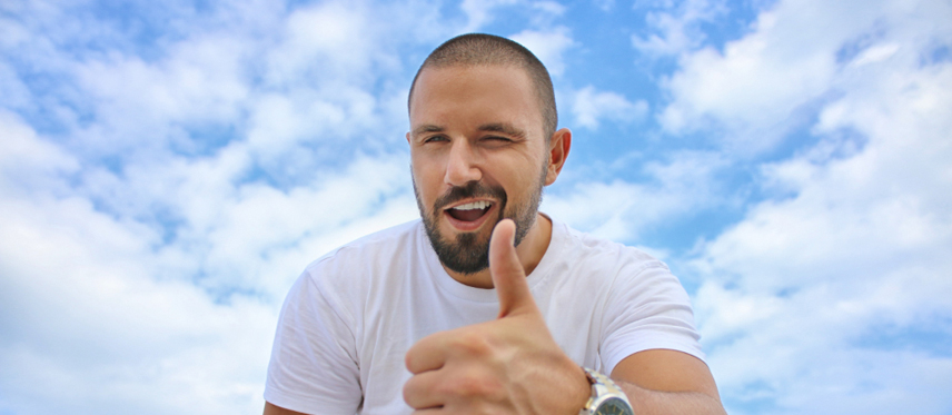 Man smiling thumbs up
